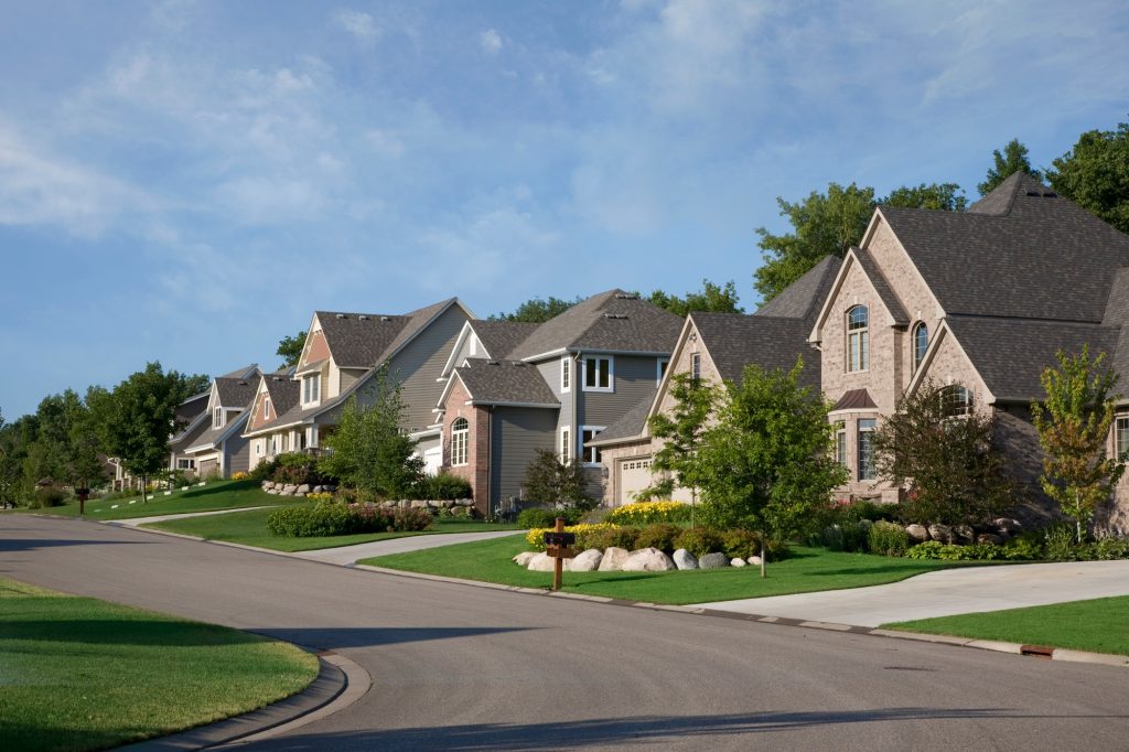 Street and houses of upscale neighborhood on a summer morning